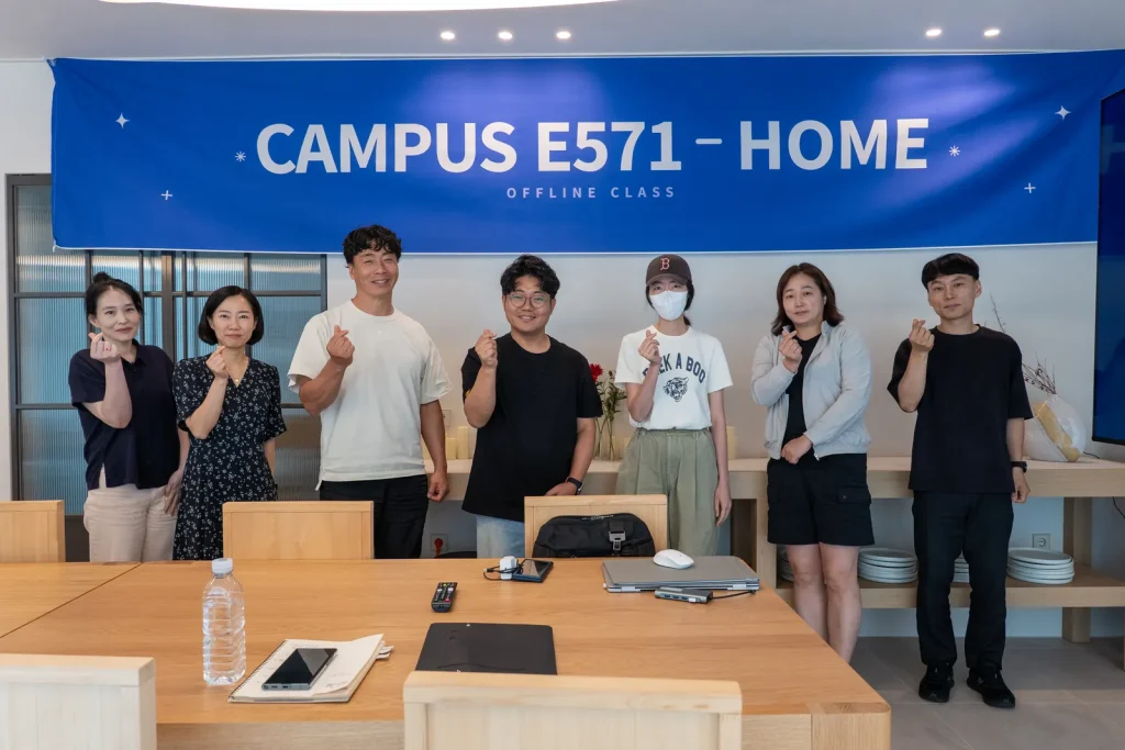 CAMPUS E571 – HOME 현수막 아래에서 마지막 회차를 마친 참가자들.